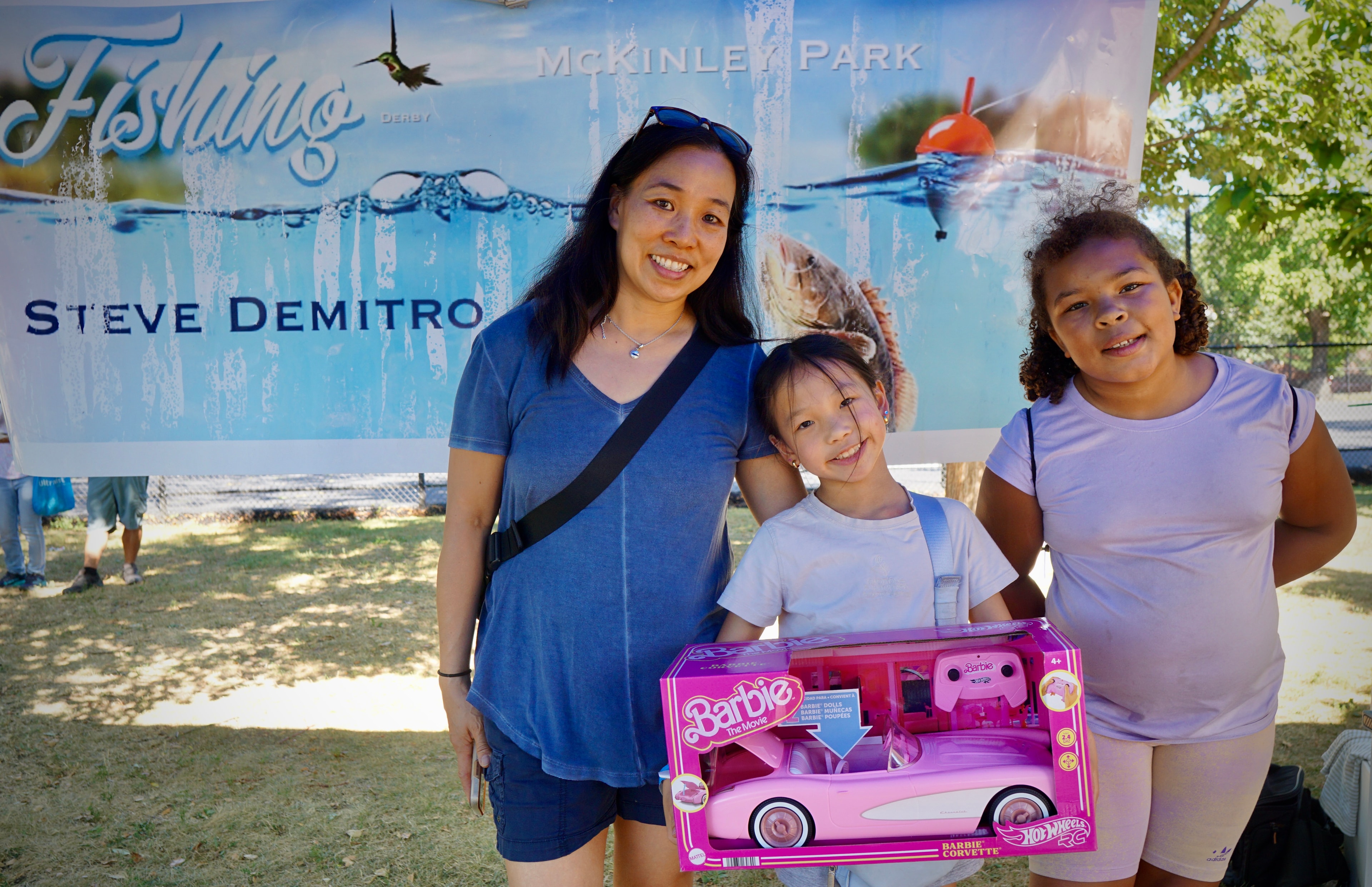 Family celebrating with prize at the Steve Demitro Kids Fishing Derby at McKinley Park