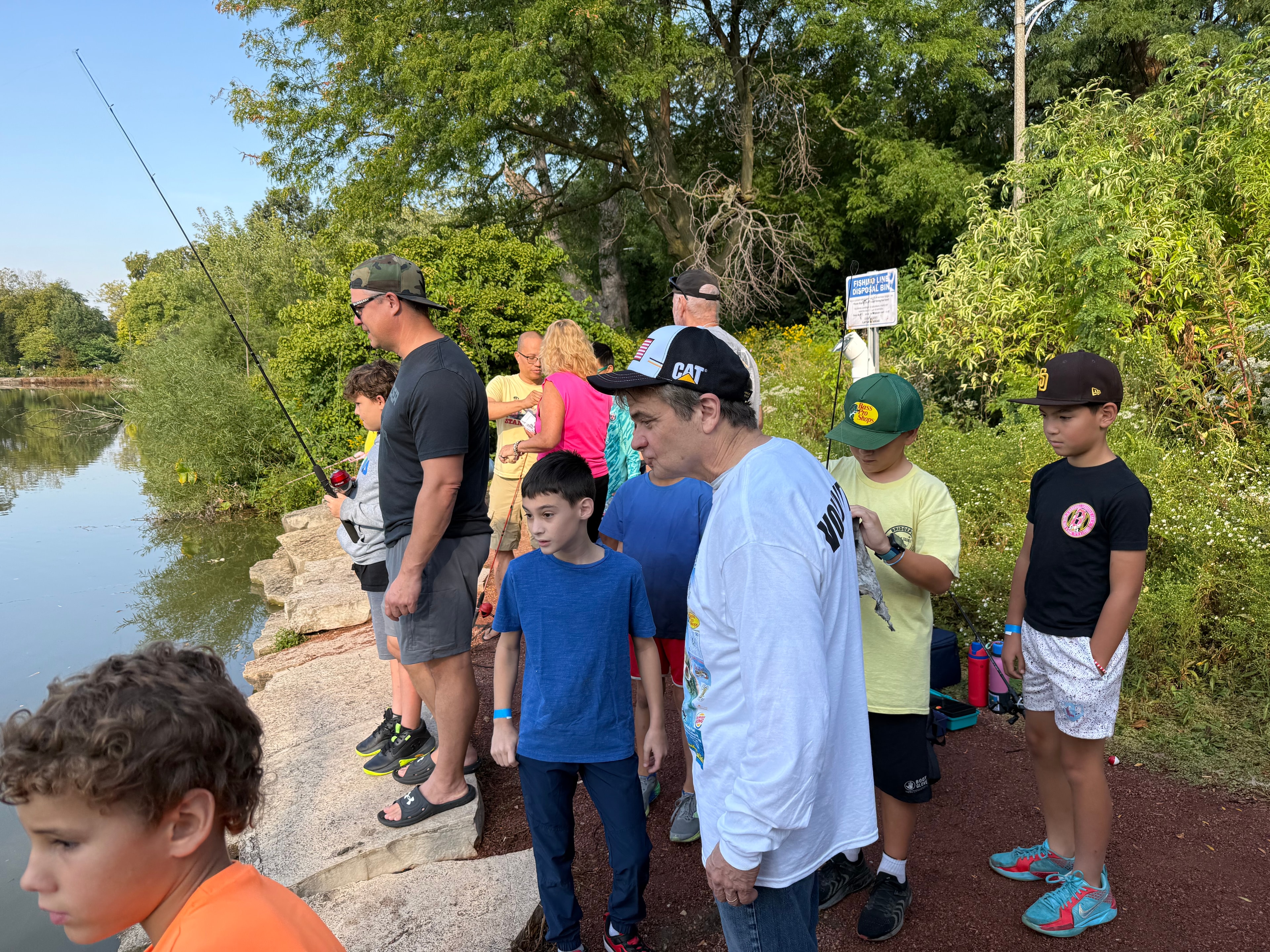 Families and children fishing along the McKinley Park Lagoon